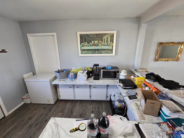 a bedroom with wooden floor and closet