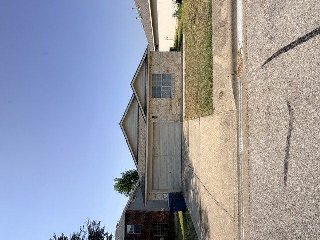 18421 Crestwind Lane Elgin, TX 78621 - Photo 2 of 34 A classic stone exterior and paved driveway provide simple curb appeal.