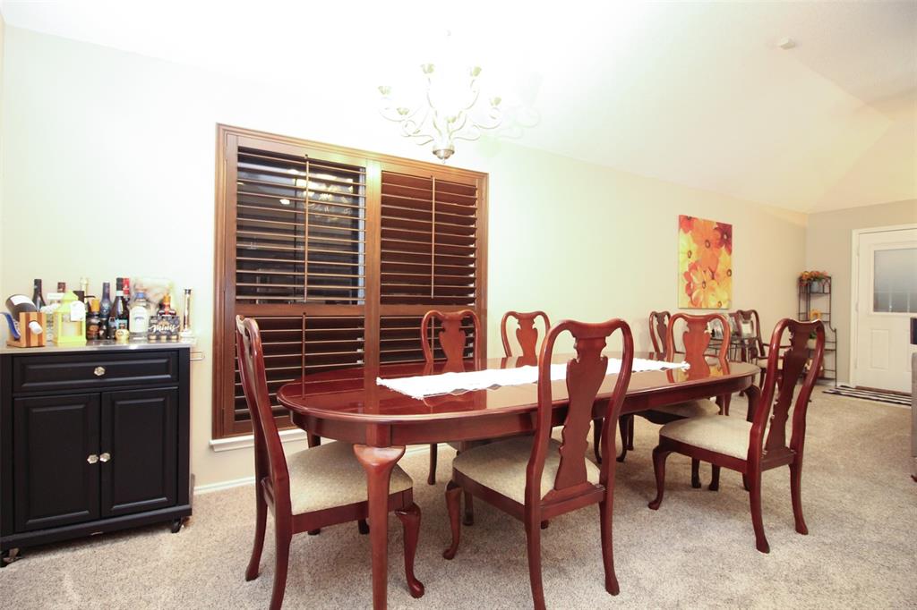 1606 Tyler Terrace Mansfield, TX 76063 - Photo 13 of 36 a dining room with a wooden table and chairs