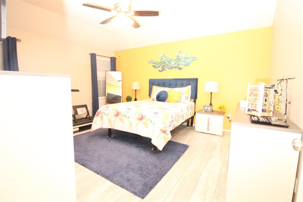 1606 Tyler Terrace Mansfield, TX 76063 - Photo 14 of 36 a bedroom with a bed lamp and a large window
