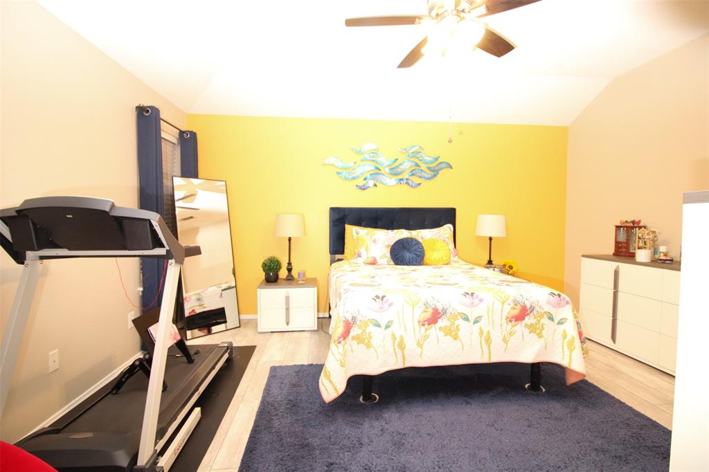 1606 Tyler Terrace Mansfield, TX 76063 - Photo 16 of 36 a bedroom with a bed and wooden floor