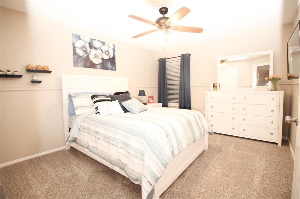 1606 Tyler Terrace Mansfield, TX 76063 - Photo 20 of 36 a bedroom with a bed and a chandelier
