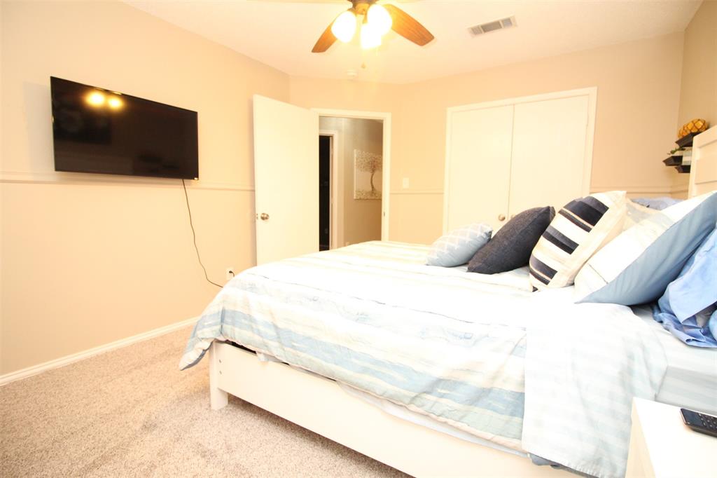 1606 Tyler Terrace Mansfield, TX 76063 - Photo 21 of 36 a bedroom with a bed and a flat screen tv