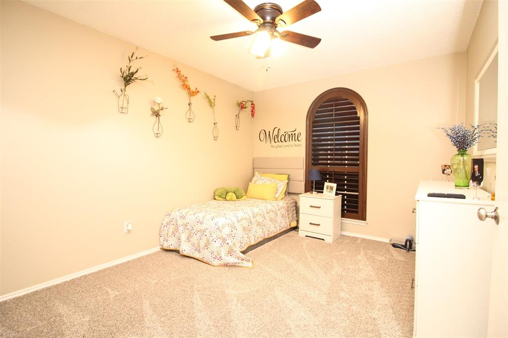 1606 Tyler Terrace Mansfield, TX 76063 - Photo 22 of 36 a bedroom with a bed and a chandelier