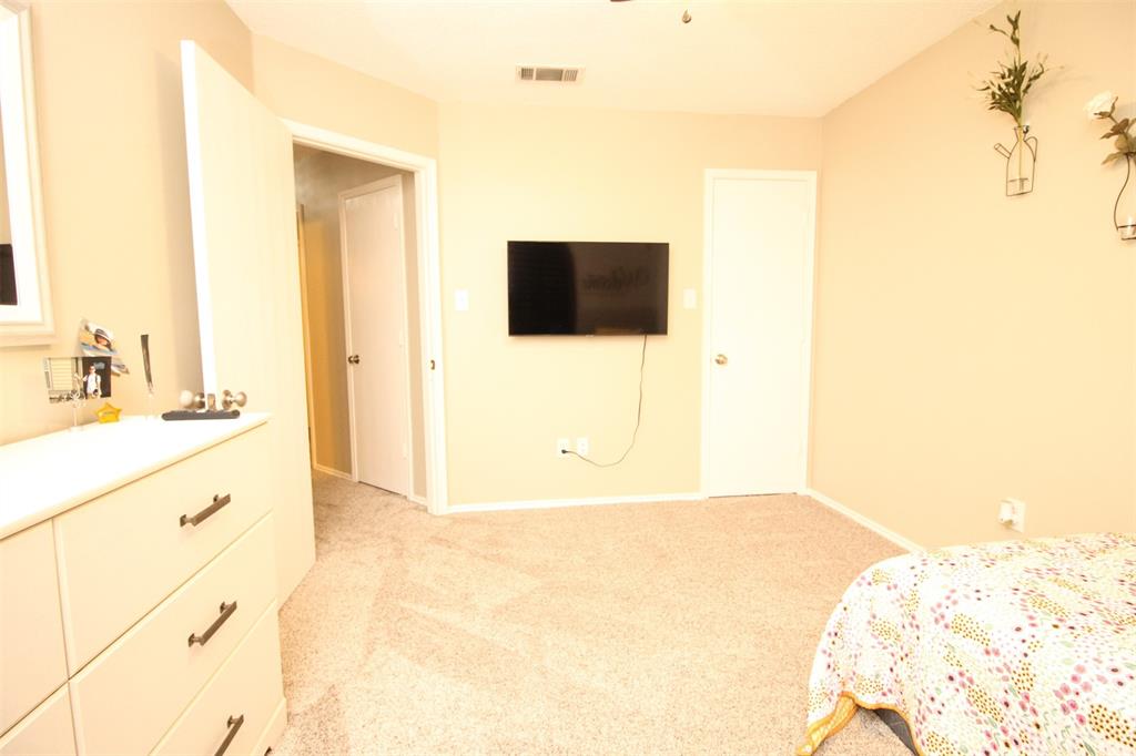 1606 Tyler Terrace Mansfield, TX 76063 - Photo 23 of 36 a bedroom with a bed and a flat screen tv