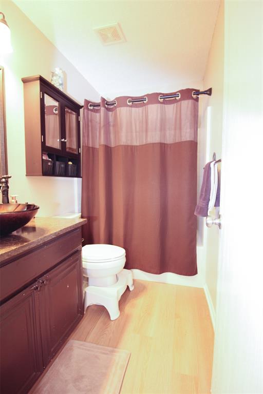 1606 Tyler Terrace Mansfield, TX 76063 - Photo 26 of 36 a bathroom with a sink a toilet and mirror