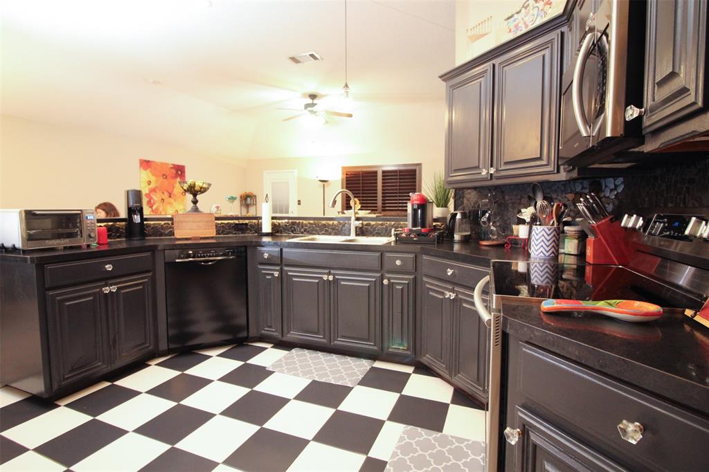 1606 Tyler Terrace Mansfield, TX 76063 - Photo 8 of 36 a kitchen with a sink stove and cabinets