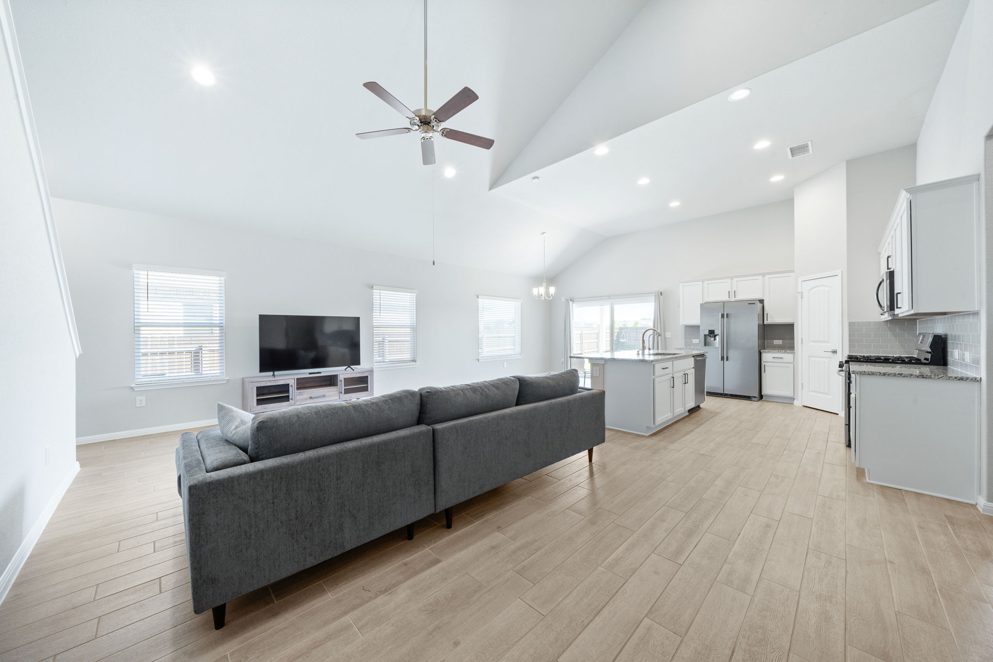 2412 Starhill Ranch Street Georgetown, TX 78628 - Photo 11 of 40 The open-concept living area features soaring vaulted ceilings, recessed lighting, and durable tile flooring throughout.