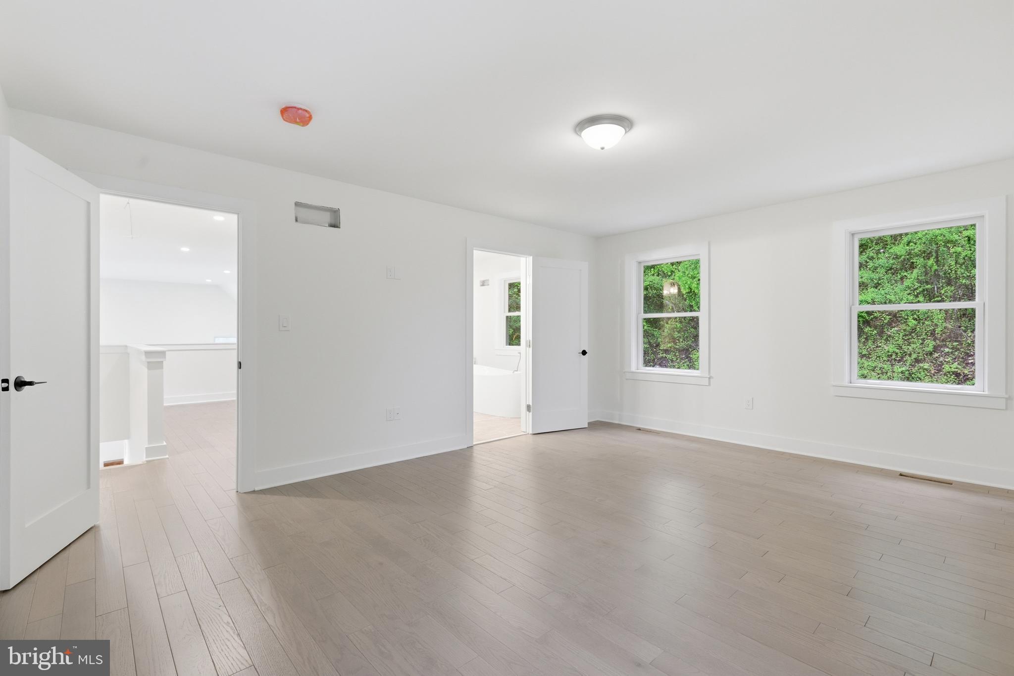 759 River Road Erwinna, PA 18920 - Photo 30 of 46 an empty room with wooden floor and windows