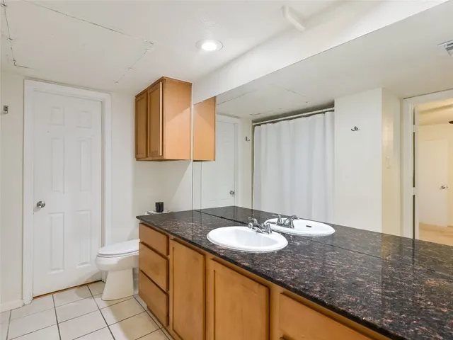 a bathroom with a sink double vanity and a toilet