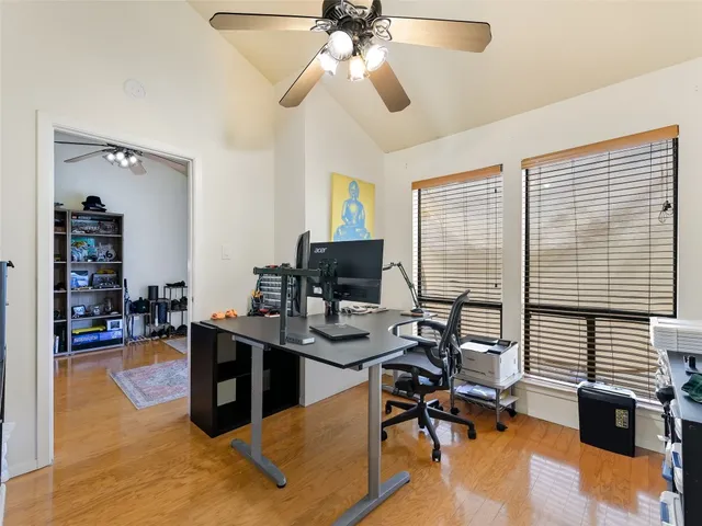 a view of a livingroom with workspace and a window