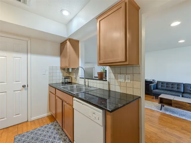 a kitchen that has a sink and a stove in it