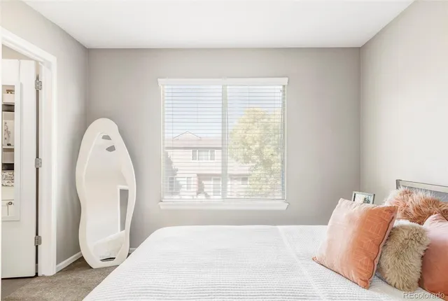 a spacious bedroom with a bed and a large window