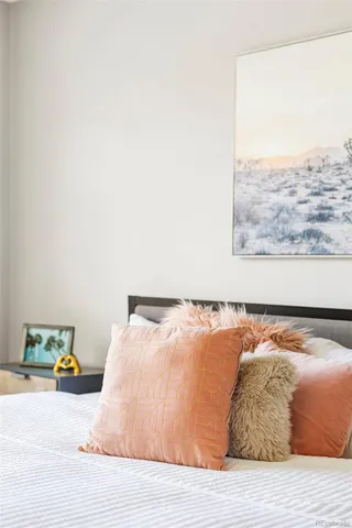 a bed sitting in a bedroom next to a large window