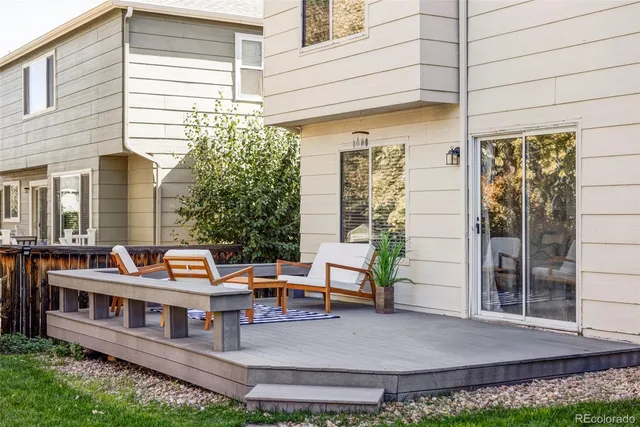 a view of a house with backyard and sitting area