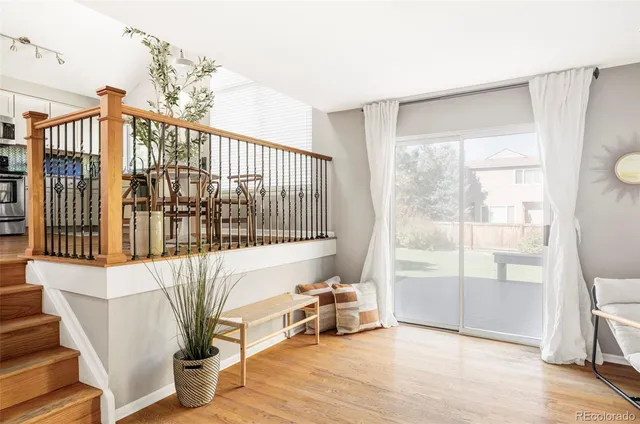 a living room with furniture and a floor to ceiling window