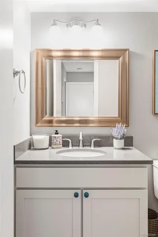 a bathroom with a sink vanity and a mirror
