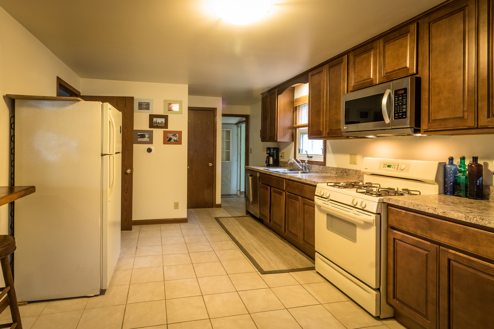5899 West Clare Road Clare, IL 60111 - Photo 4 of 32 a kitchen with stainless steel appliances granite countertop a refrigerator and a stove top oven