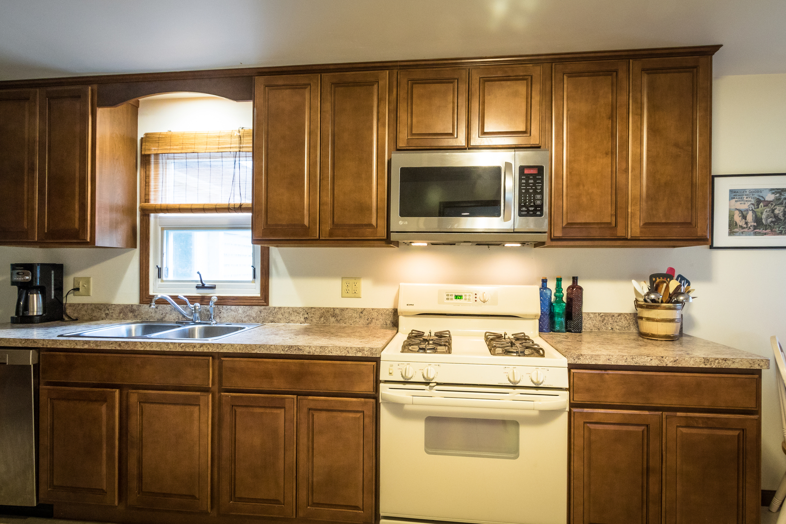 5899 West Clare Road Clare, IL 60111 - Photo 6 of 32 a kitchen with sink a microwave and cabinets
