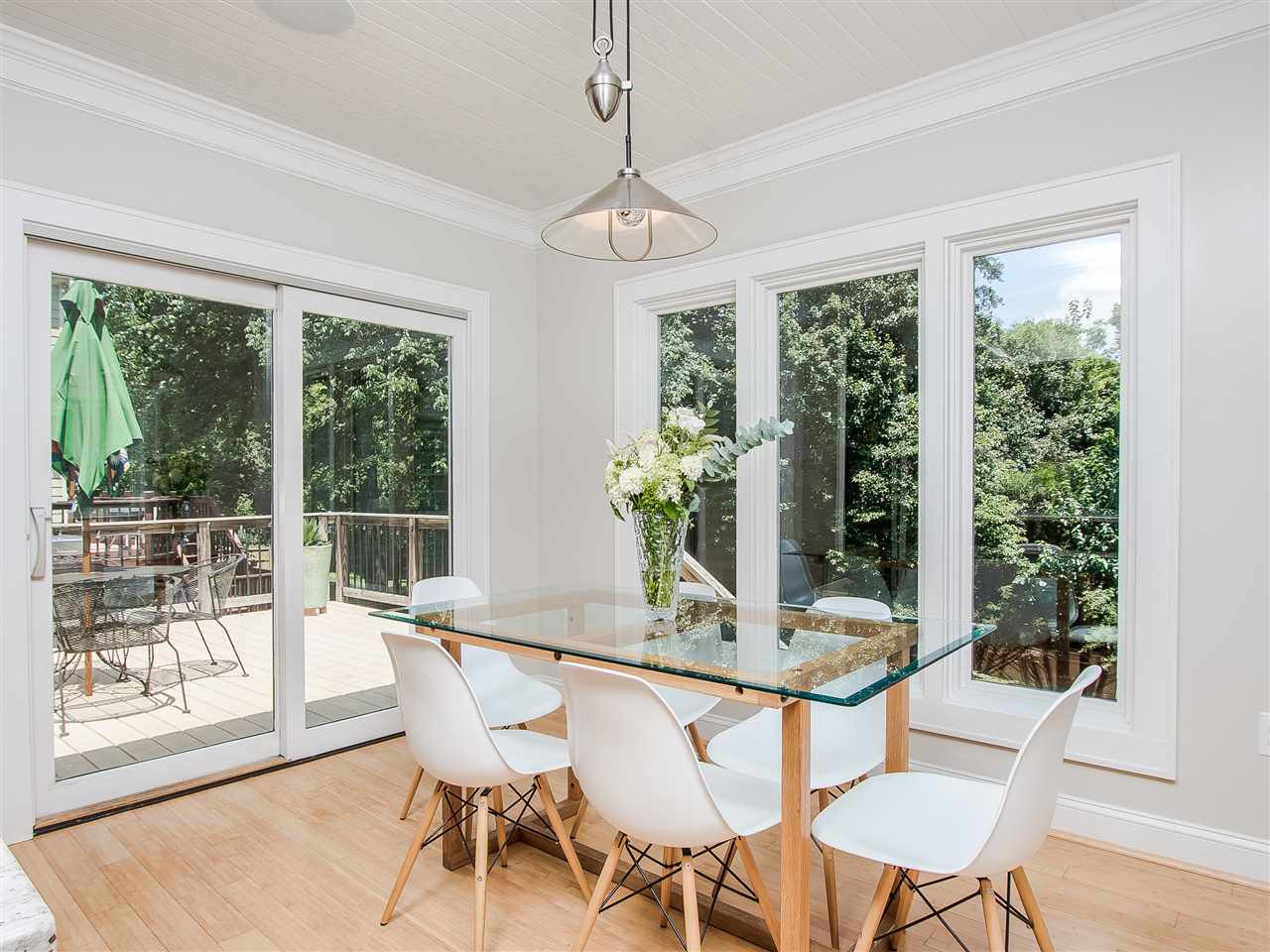 1634 Bickett Boulevard Raleigh, NC 27608 - Photo 14 of 25 While the dining area is open to the kitchen the proportion allows the feel of separation. At the same time, the expansive windows and doors allow flows onto the deck and yard beyond. Dining chandelier does not convey. Dining Room
