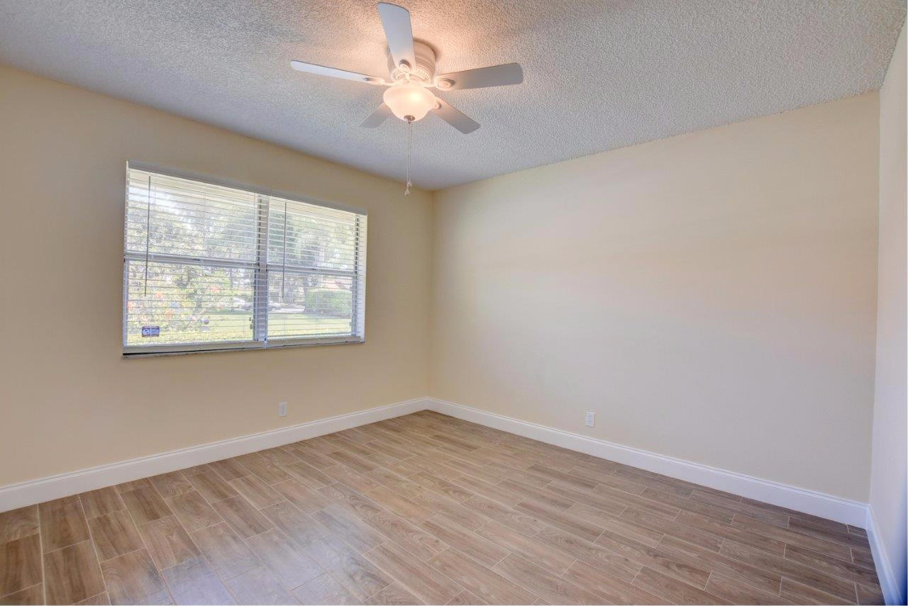 6350 Walk Circle Boca Raton, FL 33433 - Photo 16 of 29 an empty room with wooden floor and windows