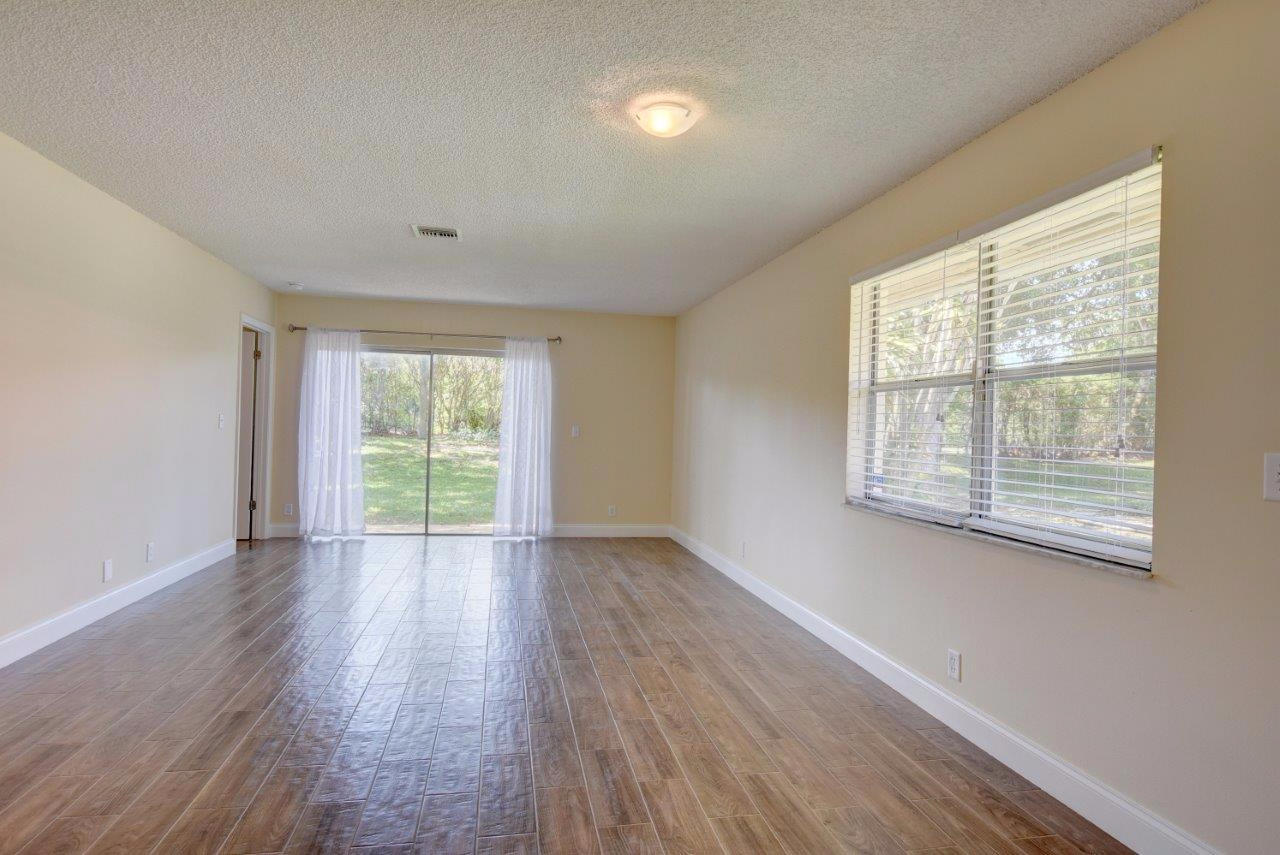 6350 Walk Circle Boca Raton, FL 33433 - Photo 2 of 29 a view of an empty room with wooden floor and a window
