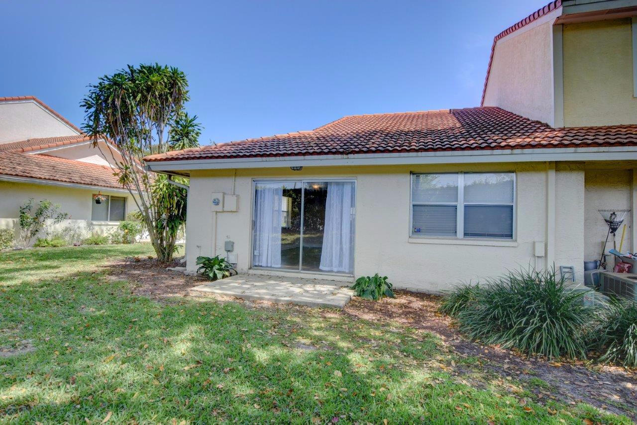6350 Walk Circle Boca Raton, FL 33433 - Photo 25 of 29 a front view of a house with garden
