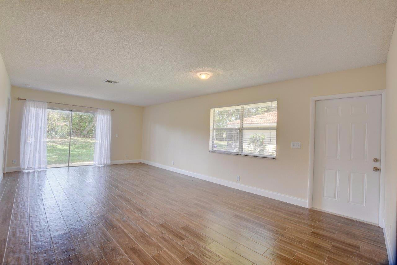 6350 Walk Circle Boca Raton, FL 33433 - Photo 3 of 29 an empty room with wooden floor and windows