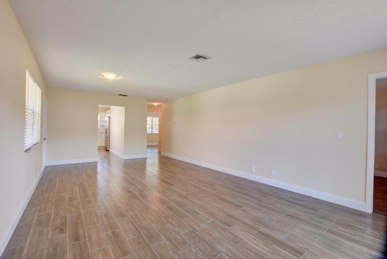 6350 Walk Circle Boca Raton, FL 33433 - Photo 4 of 29 a view of an empty room with wooden floor and a window