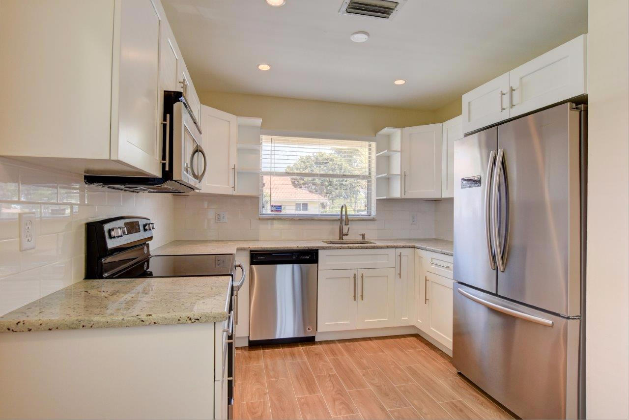 6350 Walk Circle Boca Raton, FL 33433 - Photo 8 of 29 a kitchen with stainless steel appliances granite countertop a refrigerator sink and microwave