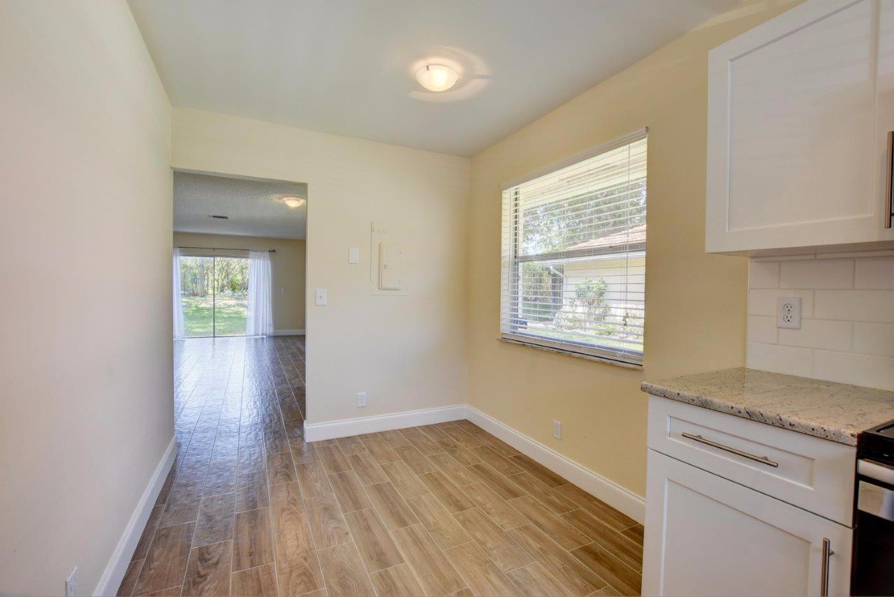 6350 Walk Circle Boca Raton, FL 33433 - Photo 10 of 29 a view of an empty room with wooden floor and a window