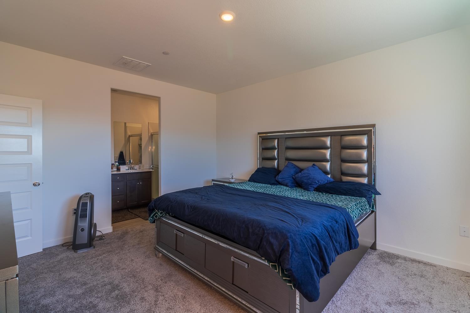 12868 Spotted Wren Circle Rancho Cordova, CA 95742 - Photo 12 of 46 a bedroom with a bed and wooden floor