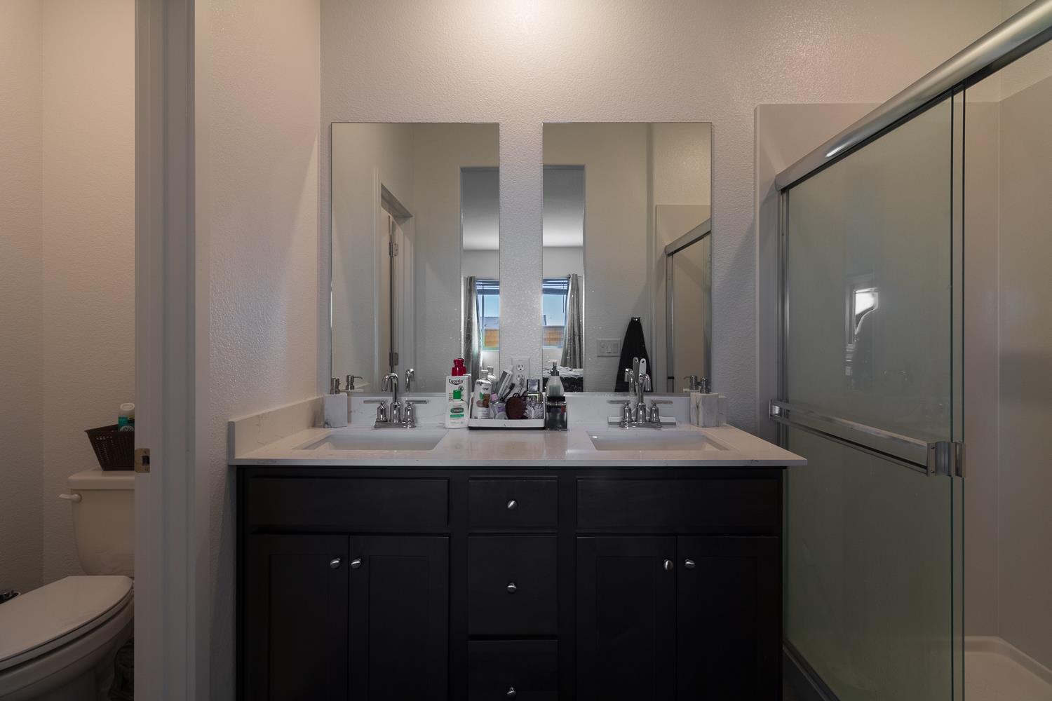 12868 Spotted Wren Circle Rancho Cordova, CA 95742 - Photo 14 of 46 a bathroom with a double vanity sink and a mirror