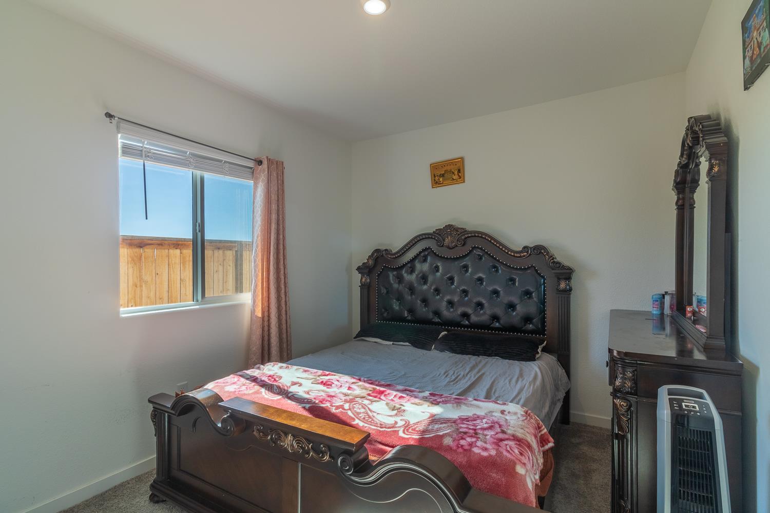 12868 Spotted Wren Circle Rancho Cordova, CA 95742 - Photo 18 of 46 a bedroom with a bed and dresser with mirror