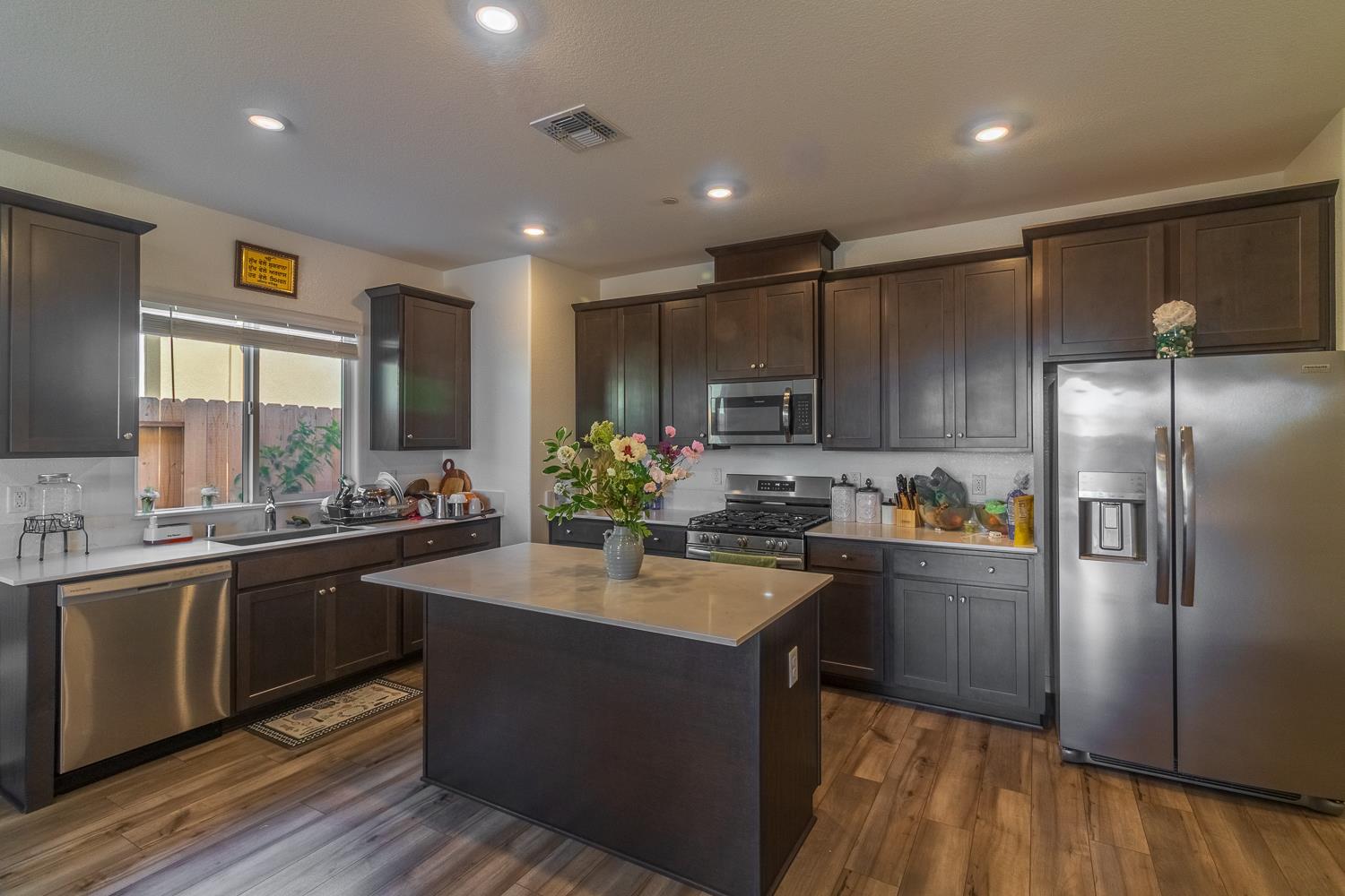 12868 Spotted Wren Circle Rancho Cordova, CA 95742 - Photo 5 of 46 a kitchen with stainless steel appliances granite countertop a sink stove and refrigerator