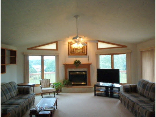 945 Lake Summerset Road Lake Summerset, IL 61019 - Photo 3 of 11 a living room with furniture a flat screen tv and a fireplace