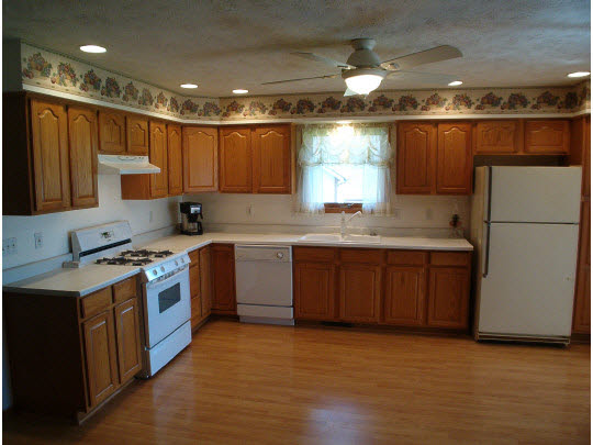 945 Lake Summerset Road Lake Summerset, IL 61019 - Photo 4 of 11 a kitchen with a sink a stove a refrigerator and a oven