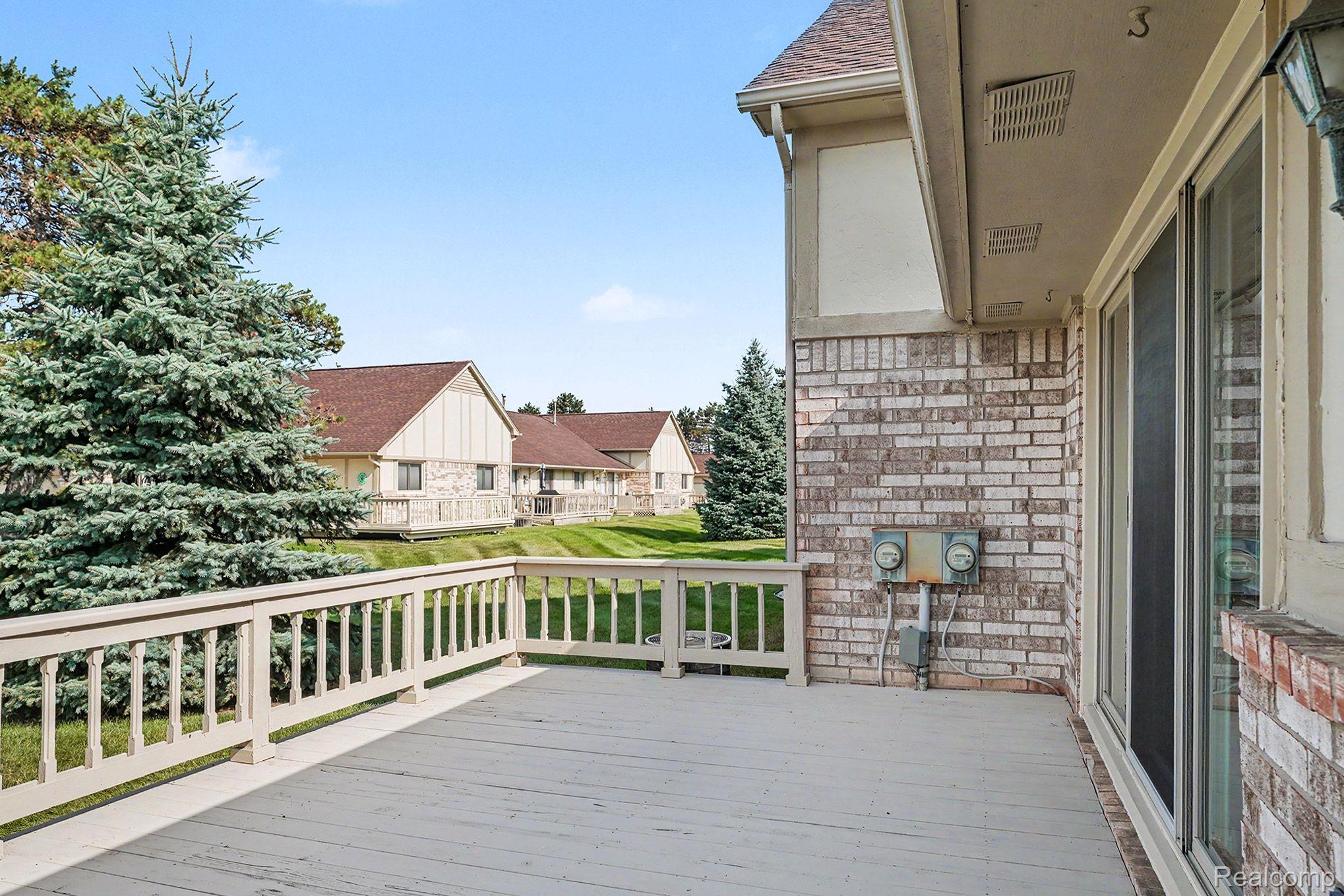 42619 Cedar Ridge Drive Clinton Township, MI 48038 - Photo 15 of 18 Expansive outdoor deck featuring a painted wood surface and a decorative balustrade