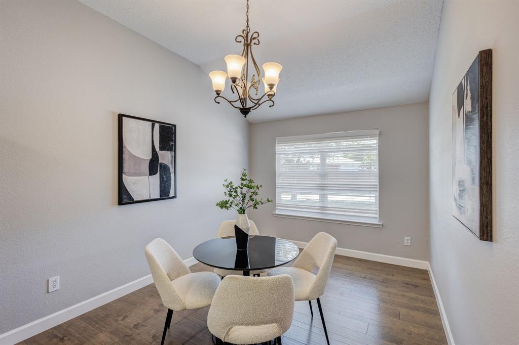 7218 Compass Point Drive Rowlett, TX 75089 - Photo 13 of 30 Dining room featuring wood finished floors and a chandelier