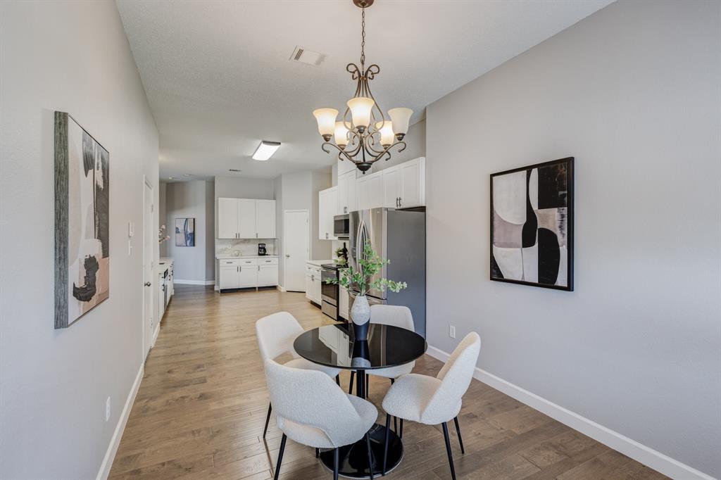 7218 Compass Point Drive Rowlett, TX 75089 - Photo 20 of 30 Dining space with a chandelier and light wood-type flooring