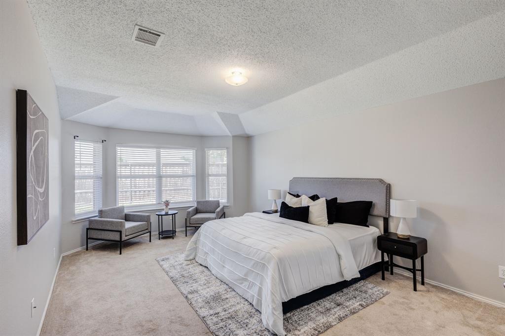 7218 Compass Point Drive Rowlett, TX 75089 - Photo 25 of 30 Bedroom featuring light colored carpet and a textured ceiling
