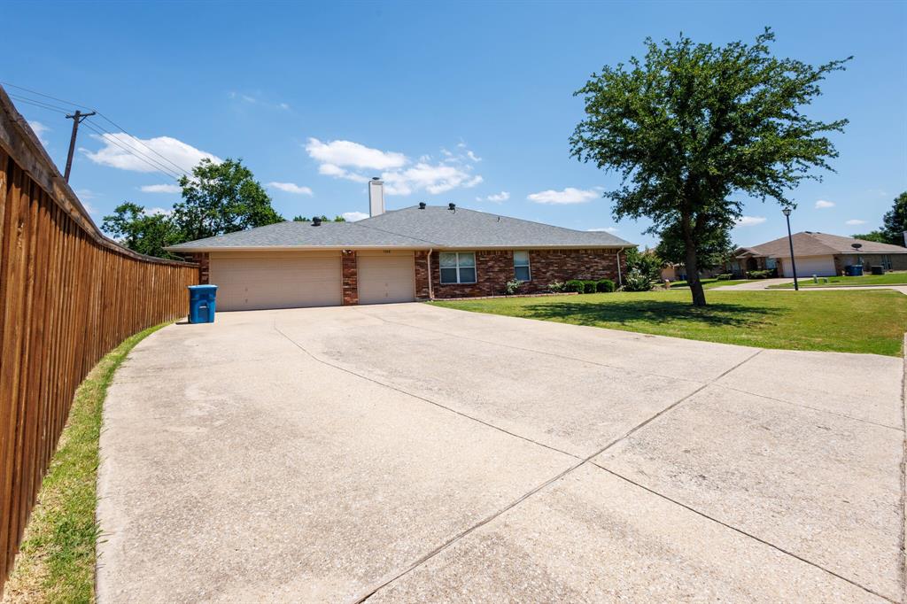 7218 Compass Point Drive Rowlett, TX 75089 - Photo 3 of 30 Single story home featuring a chimney, a garage, concrete driveway, a front yard, and brick siding