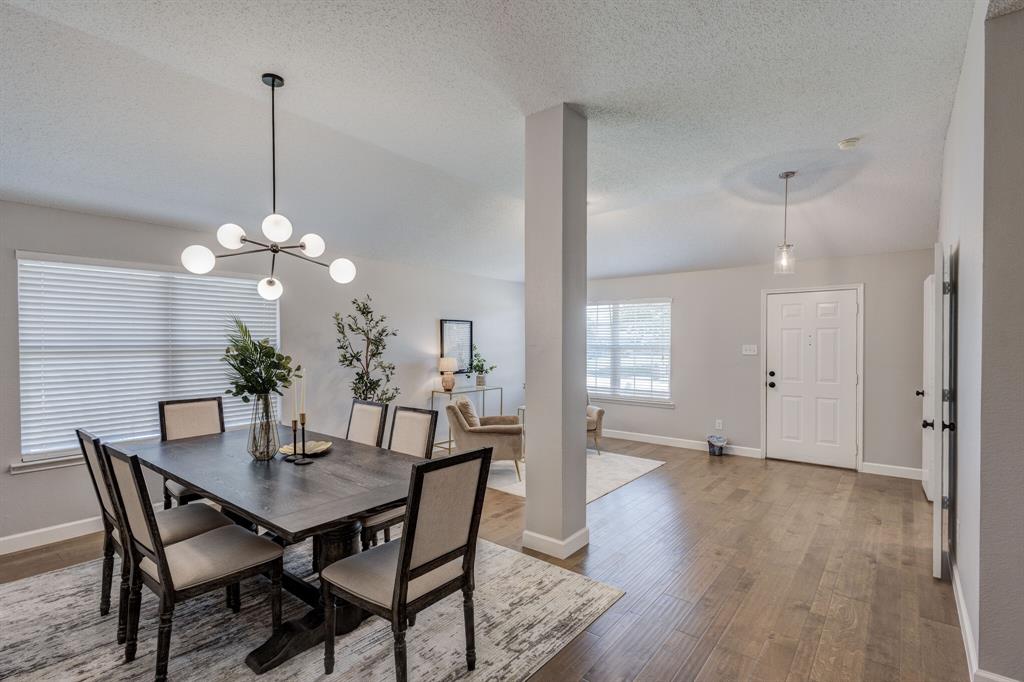 7218 Compass Point Drive Rowlett, TX 75089 - Photo 10 of 30 Dining space with a textured ceiling, wood finished floors, and a chandelier