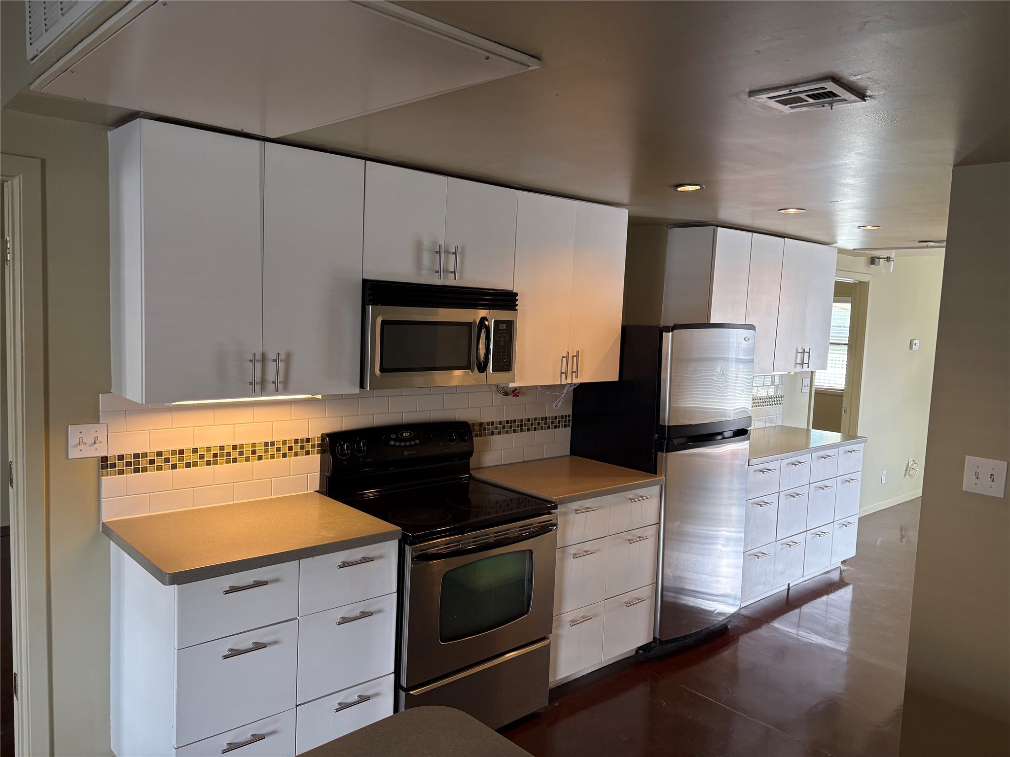2408 Leon Street, Unit 206 Austin, TX 78705 - Photo 5 of 9 a kitchen with stainless steel appliances a stove microwave and refrigerator