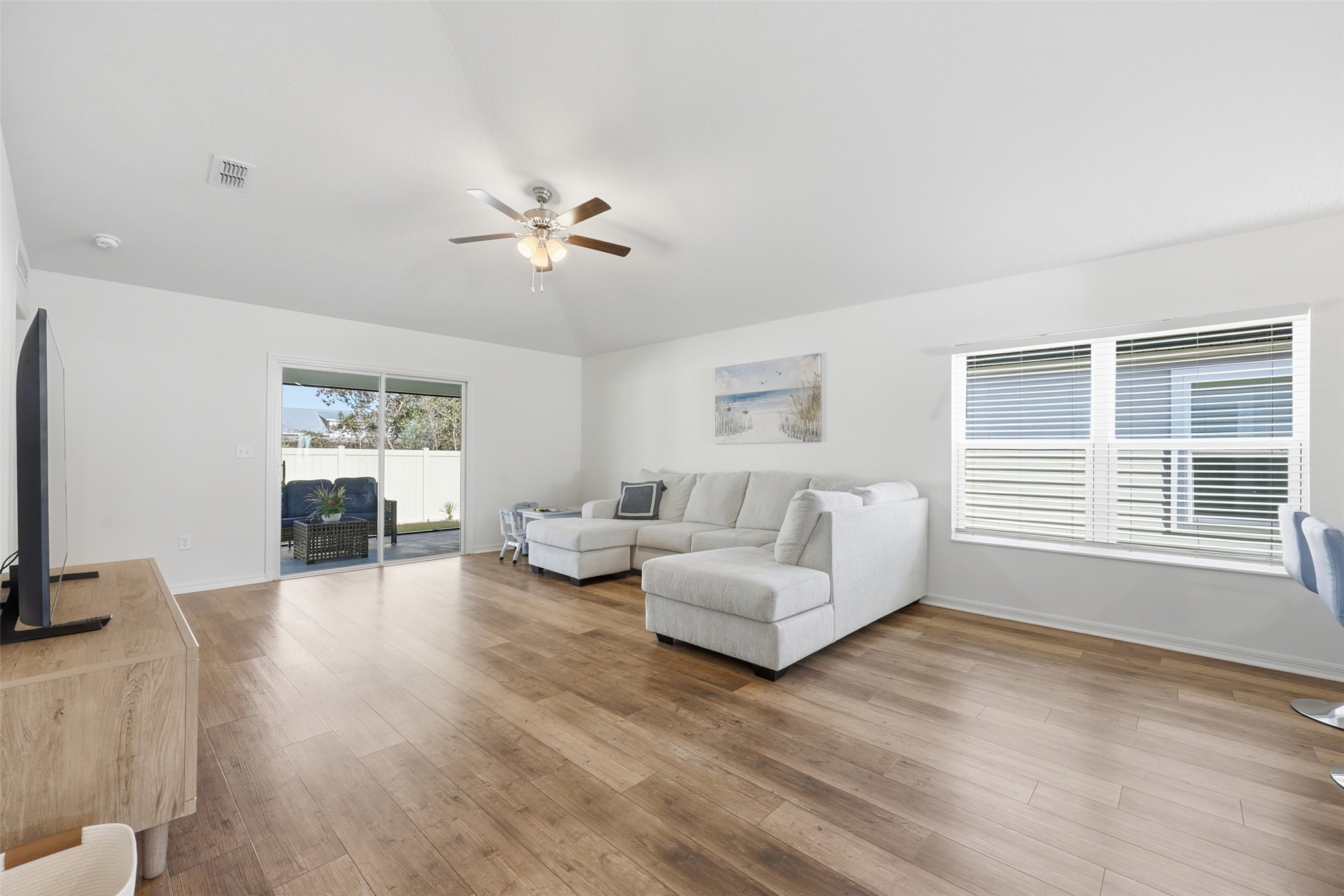 37474 Whisper Way Hilliard, FL 32046 - Photo 14 of 31 a living room with furniture two window and a flat screen tv