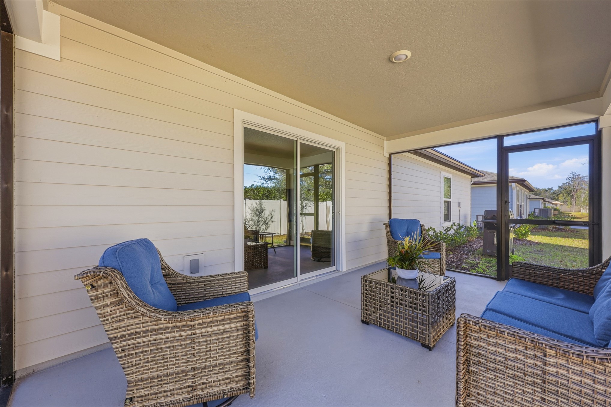 37474 Whisper Way Hilliard, FL 32046 - Photo 28 of 31 a living room with furniture and a floor to ceiling window