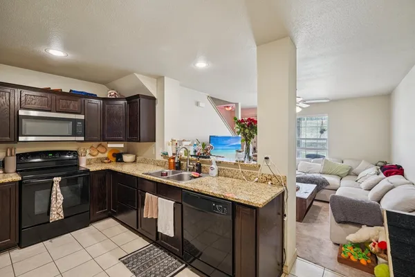 a kitchen with a sink stove and cabinets