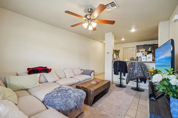 a living room with furniture and white walls