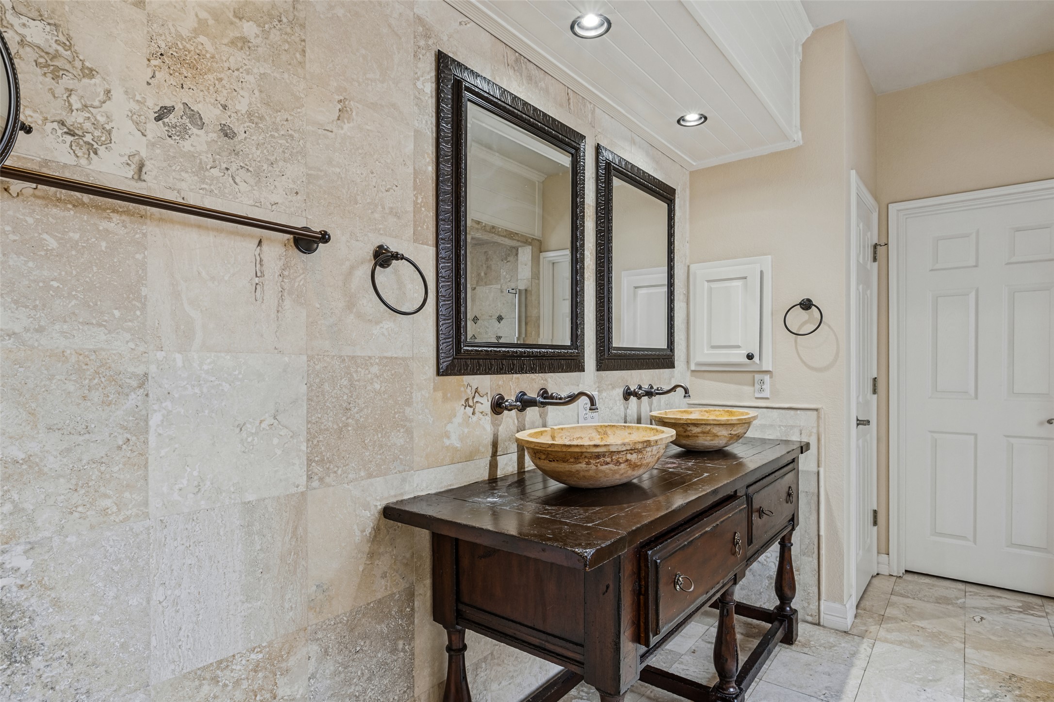 2832 Grimes Ranch Road Austin, TX 78732 - Photo 14 of 23 Elegance defines this space with natural stone wall tiles and dual vessel sinks.