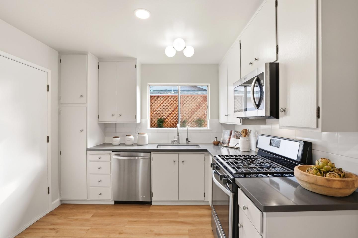 882 San Rafael Avenue Mountain View, CA 94043 - Photo 15 of 50 a kitchen with stainless steel appliances a sink stove and cabinets